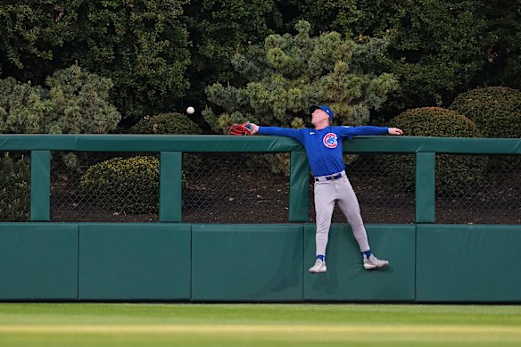 Pete Crow-Armstrong #4 of the Chicago Cubs is unable to make the catch on a solo home run that was hit by Kyle Schwarber #12 of the Philadelphia Phillies in the bottom of the first inning at Citizens Bank Park on April 13, 2026 in Philadelphia, Pennsylvania. 