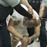 In a photo provided by the US District Court for Maryland, a man identified as Kilmar Abrego Garcia is led through the Terrorism Confinement Centre in Tecoluca, El Salvador.