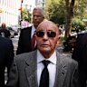Joe Lewis, centre, leaving court in 2023 after appearing on insider trading charges for which he was convicted.