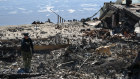 A K9 unit from the Los Angeles County Sheriff’s department searches for possible human remains in the ashes of burned houses at Malibu Beach.