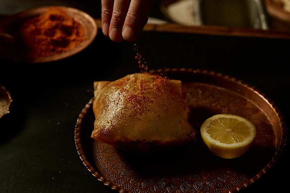 Tunisian pastry filled with tuna, potato, harissa and more.