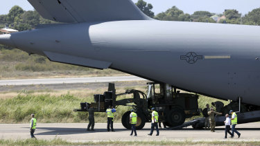 A loader disembarks from A United States Air Force C-17 cargo plane loaded with humanitarian aid, after it landed at Camilo Daza airport in Cucuta, Colombia, on Saturday.