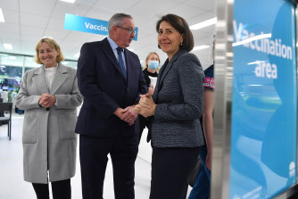 NSW Premier Gladys Berejiklian (right) and Health Minister Brad Hazzard at the mass vaccination centre at Sydney Olympic Park on Monday.