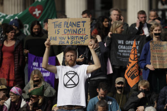 Extinction Rebellion climate change protesters hold placards calling for action on climate change during a rally in Trafalgar Square, London, last year.