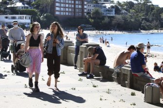 Crowds enjoying the fine weather and getting out to exercise at Balmoral Beach in Middle Harbour.