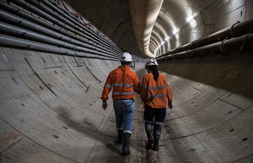 Abdalah El Sayed and engineer Jaime Cheuk walk down the Sydney metro tunnel. 