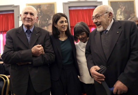 Rome's mayor Virginia Raggi, second from left, with Holocaust survivors Sami Modiano, left, and Piero Terracina, right, during an event to commemorate the International Holocaust Remembrance Day, 2017. 