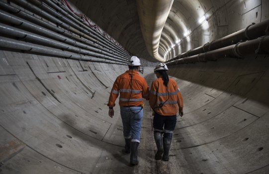 Abdalah El Sayed and engineer Jaime Cheuk walk down the Sydney metro tunnel. 