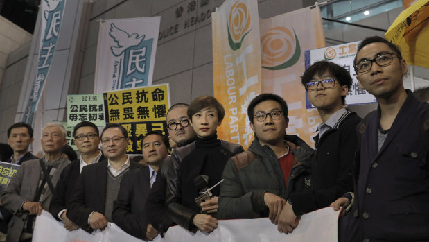 Tanya Chan stands with other current and former lawmakers for a picture before walking toward a police station in Hong Kong.