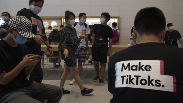 A visitor to an Apple store wears a t-shirt promoting Tik Tok in Beijing.
