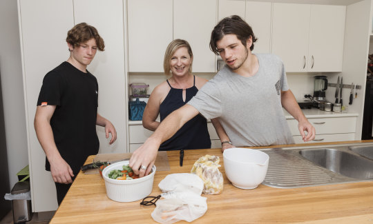 Karen Porter with her two boys Cameron Morris and Lachie Morris, at their Fairlight home where they share the chores. 