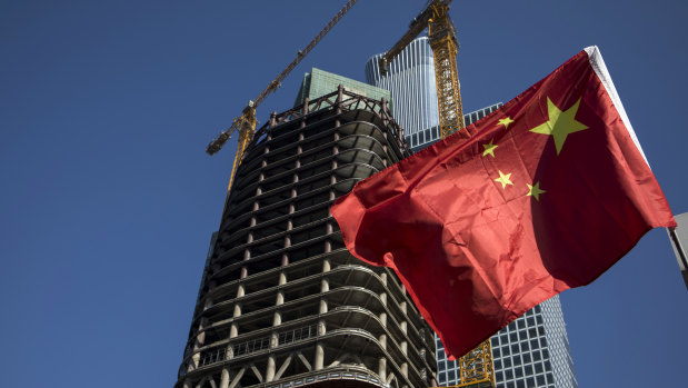 A Chinese flag flying in Beijing's CBD: China is making swift advances with an elaborate system for measuring the social creditworthiness of companies.