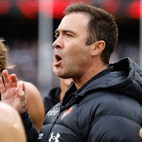 Brad Scott addresses his players during Essendon’s Anzac Day clash with Collingwood.