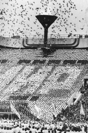A flock of pigeons are released after the Olympic flame is ignited by Sergei Belov at the Opening Ceremony