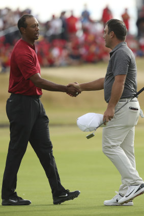 Tamed: Francesco Molinari and Tiger Woods shake hands after the final hole of the 147th British Open.