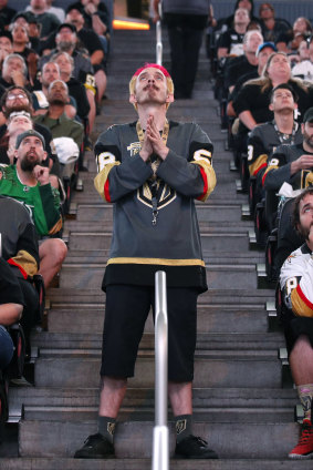 A Vegas fan prays for a goal.