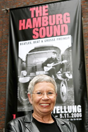 Astrid Kirchherr poses in front of a poster of the exhibition 'The Hamburg Sound' in the Hamburg Museum, in Hamburg, in 2006.
