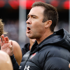 Brad Scott addresses his players during Essendon’s Anzac Day clash with Collingwood.