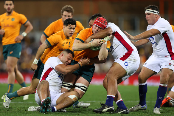 Harry Wilson (being tackled) has pledged to take the attack to Langi Gleeson and ultimately win back his Wallabies jumper.