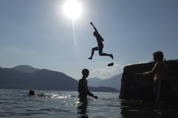 Boys dive into Lake Como, at Lierno, northern Italy.