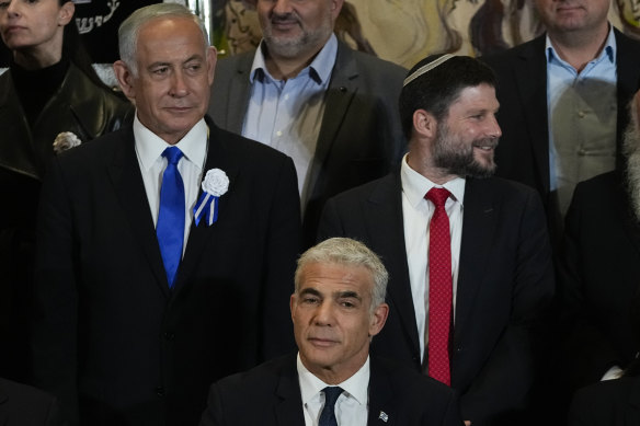 Israeli Prime Minister Yair Lapid, center, Likud Party leader Benjamin Netanyahu, left, far-right Israeli lawmaker Bezalel Smotrich after the swearing-in ceremony for Israeli lawmakers at the Knesset, Israel’s parliament in November.
