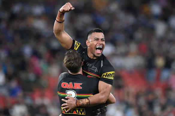 Intercept hero Stephen Crichton celebrates Penrith’s memorable grand final win with teammate Paul Momirovski.