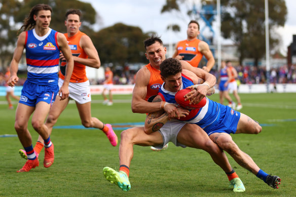 Tom Liberatore of the Western Bulldogs is taken to ground against GWS at Mars Stadium.