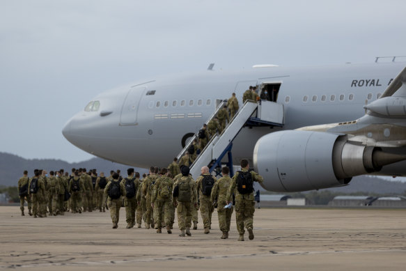 Australian soldiers board an RAAF aircraft in Townsville in 2021.