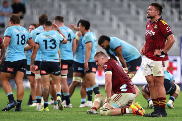 Highlanders players are shattered as the Waratahs celebrate the win.