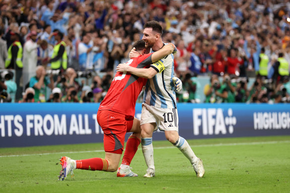 Emi Martinez and Lionel Messi of Argentina celebrate the win over the Netherlands.