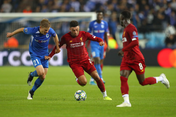 Liverpool's Alex Oxlade-Chamberlain is challenged by Genk's Jere Uronen.