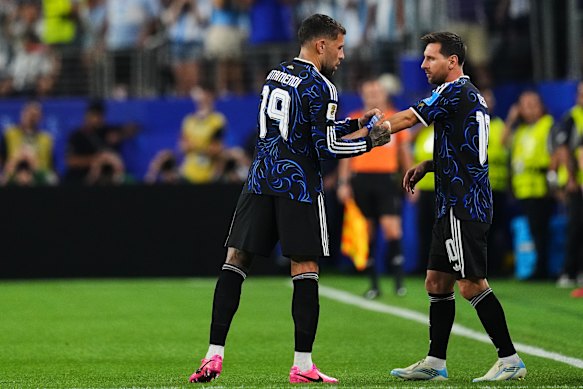 Otamendi hands over the armband.