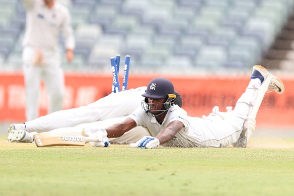 Ashley Chandrasinghe of Victoria slides in to get back into his crease. 