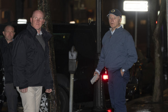 President Joe Biden reacts after hearing a loud bang as he leaves his campaign headquarters.