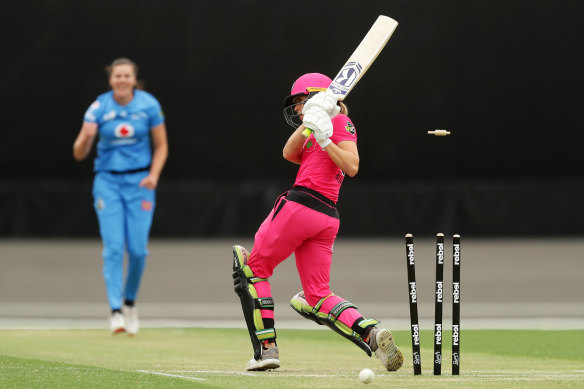 Sixers batter Erin Burns gets bowled by Tahlia McGrath of the Strikers.