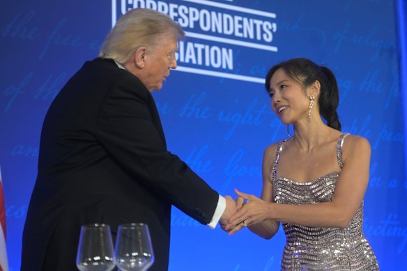 President Donald Trump congratulates outgoing White House Correspondents Association president Weijia Jiang.