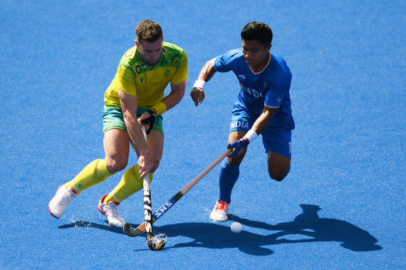 Tom Wickham and Nilakanta Sharma compete for the ball. 