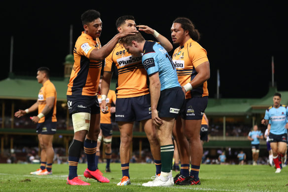 Will Harrison of the Waratahs is consoled by Brumbies players after missing a conversion to draw the game.