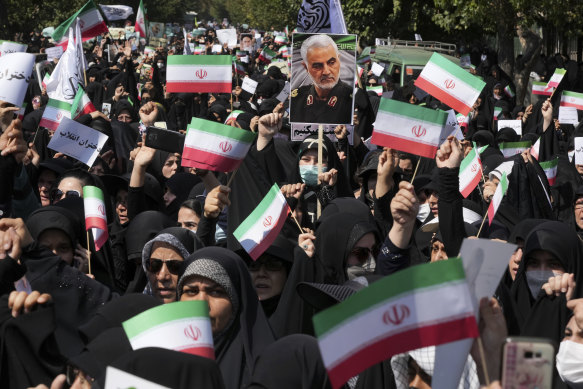 Iranian pro-government demonstrators attend a rally after their Friday prayers to condemn recent anti-government protests over the death of a young woman in police custody