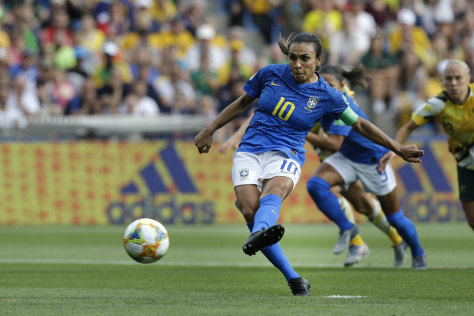 Marta scores from the spot for Brazil.