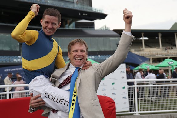 Jockey Jason Collett and trainer Bjorn Baker celebrate Stefi Magnetica’s win.
