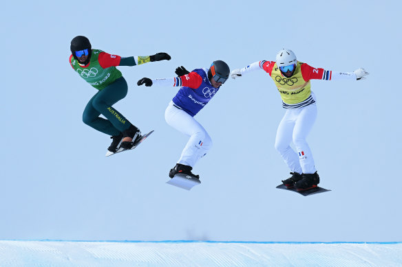 Cameron Bolton of Australia, Merlin Surget and Loan Bozzolo of France compete during the men’s snowboard cross quarter-finals.