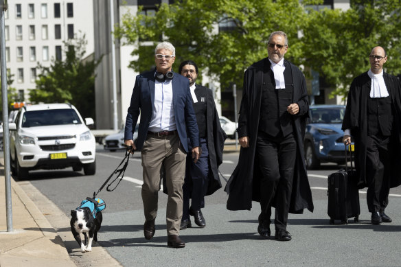 McBride arrived at the ACT Supreme Court with his therapy dog Jake.