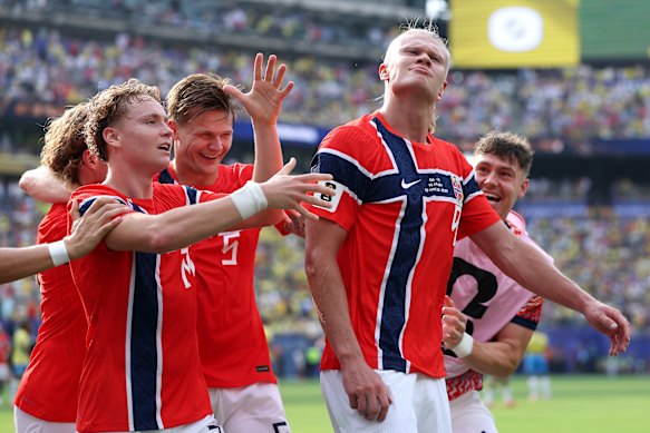 Haaland celebrates with Schjelderup, left, and Norway teammates.