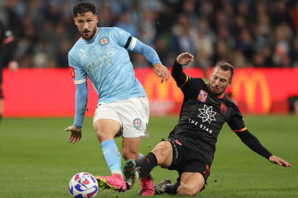 Mathew Leckie of Melbourne City gets the ball away from Adam Le Fonder.
