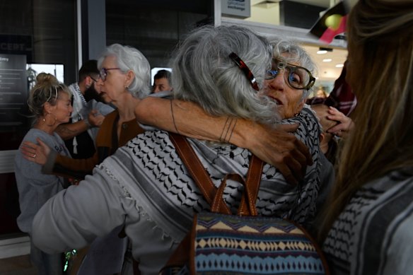 Mokotow is embraced by waiting family, friends and supporters at Sydney International Airport on Monday.