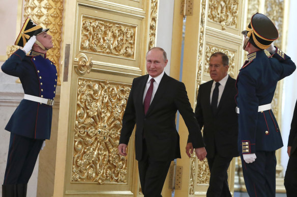 Putin and Foreign Minister Sergei Lavrov (back, right) have also been sanctioned but authorities say their personal funds are hard to track down.
