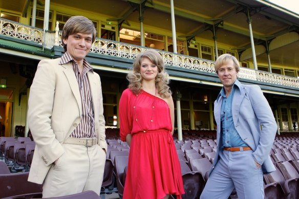 Abe Forsythe, left, played John Cornell in “Howzat! Kerry Packer’s War” about the World Series Cricket revolution. Pictured also are Cariba Heine (Delvene Delaney) and Travis McMahon (Paul Hogan).