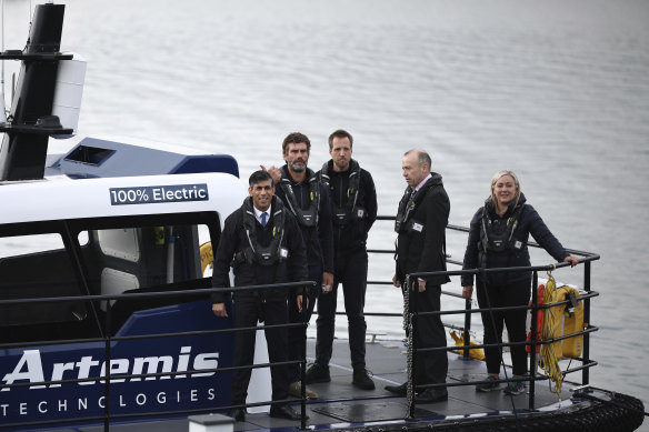 Britain’s Prime Minister and Conservative Party leader Rishi Sunak, left, and Northern Ireland Secretary Chris Heaton-Harris, second right, wait on board an Artemis Technologies boat at a dockyard in Belfast, on Friday.