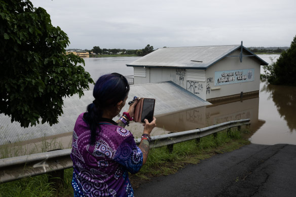A local stops to take a photo of Clarence River Sailing Club.